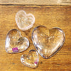 Group of four Simon Pearce clear glass hearts.