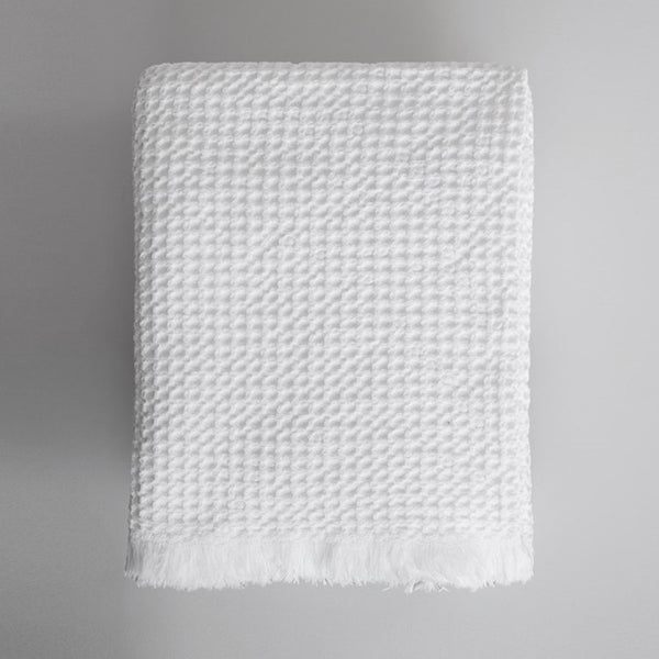 One Mungo white waffle weave bath towel, folded.