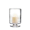 Simon Pearce Nantucket hurricane with included pillar candle placed inside. This round candleholder is handmade of clear glass, is 9.5 inches high and 7.25 inches wide, has a wide, raised base, and straight sides.