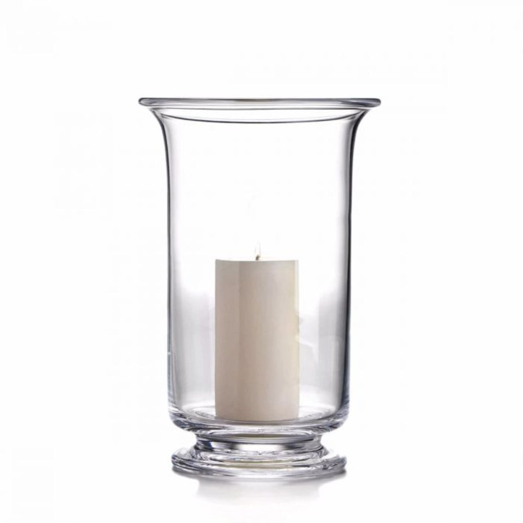 One extra large Simon Pearce Revere Hurricane with the included pillar candle inside. These clear glass candleholders are 13 inches tall and 8.25 inches wide and have a sturdy flared base and flared top.