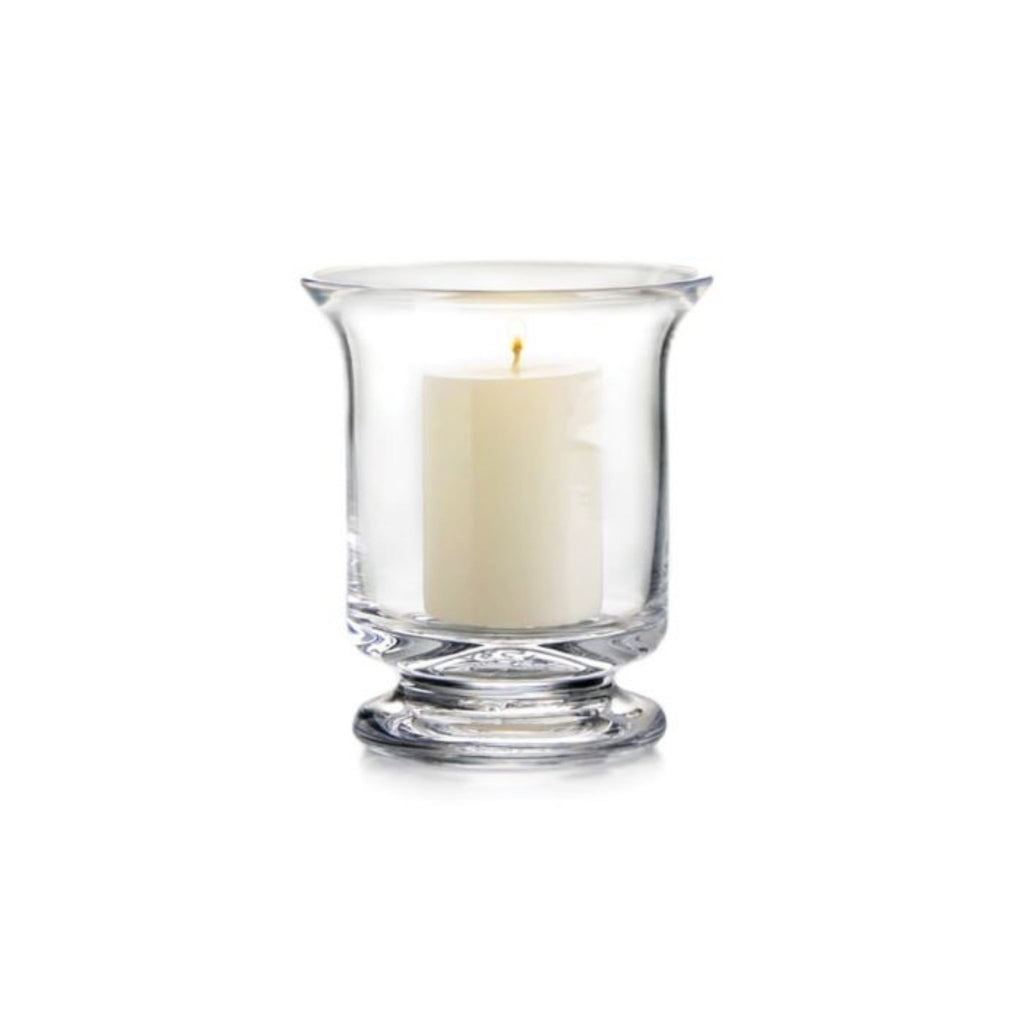 One small Simon Pearce Revere Hurricane with the included pillar candle inside. These clear glass candleholders are 5.25 inches tall and 4.5 inches wide and have a sturdy flared base and flared top.