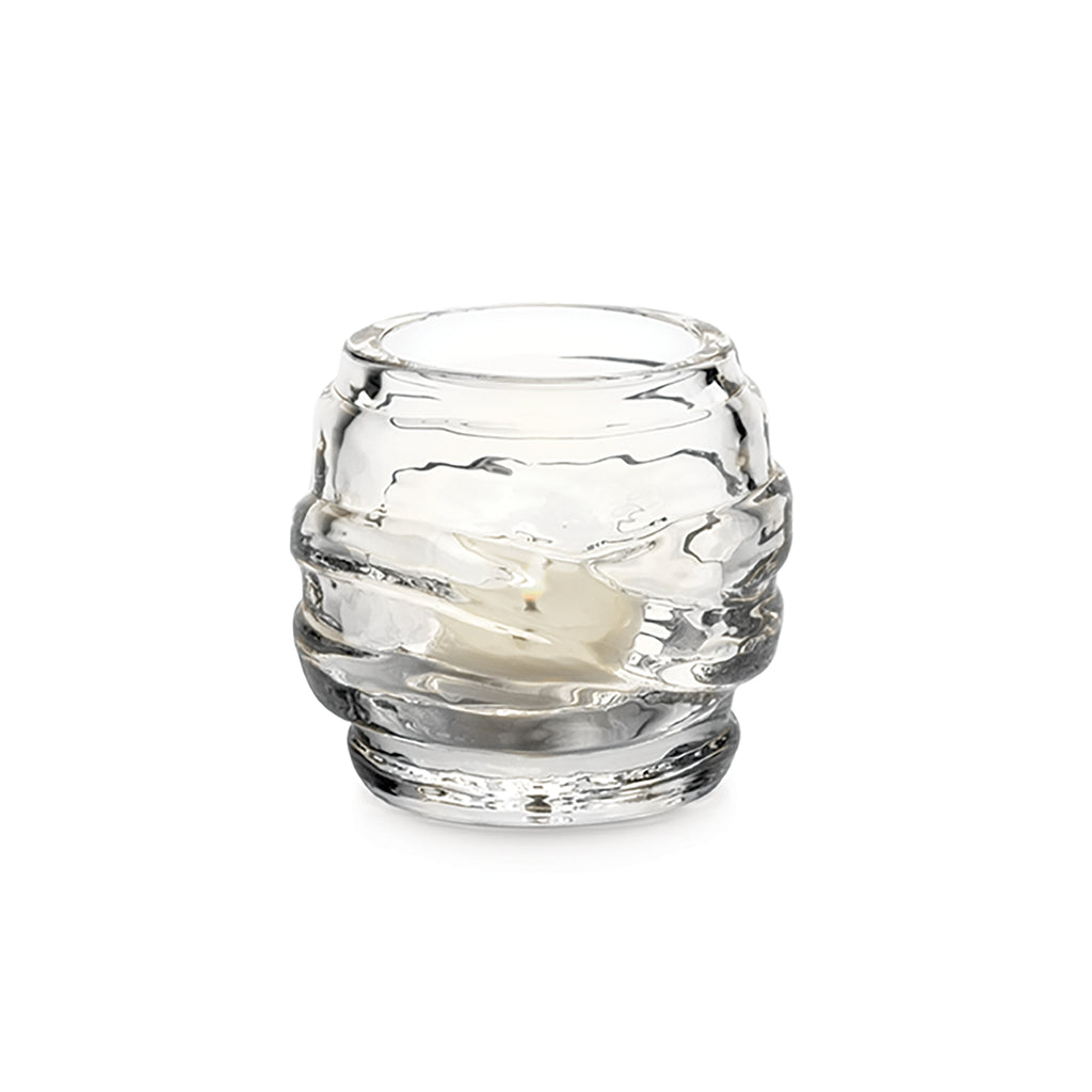 Simon Pearce's Waterbury tealight is clear glass and features a ripple design. Contains a votive candle.