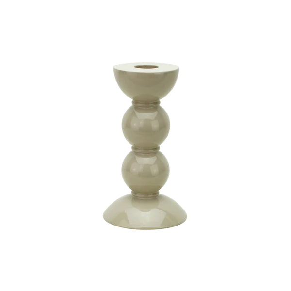 One small taupe colored bobbin shaped candlestick.