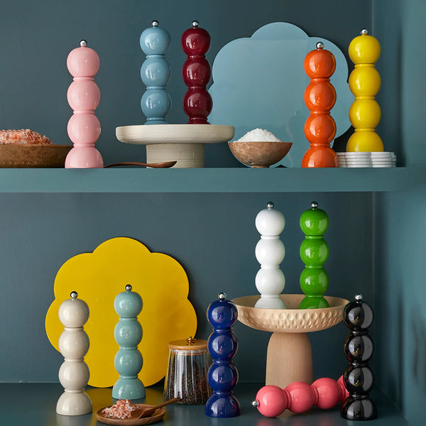 The Bobbin salt and pepper mill is shaped like three balls resting on top of each other. Made of Acacia wood and painted in fun colors and lacquered. This is a picture of a collection of 12 mills, all in different, bright colors.