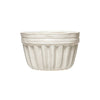 One white fluted stoneware bowl with a ridged rim.