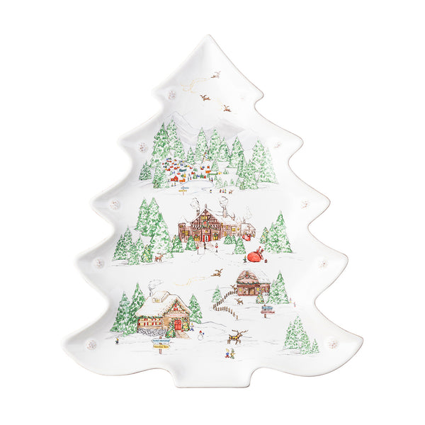 A tree-shaped platter from Juliska's North Pole collection is decorated with fir trees, a snowy background, reindeer, Santa's workshop and the elves' cottage. 