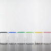 Six clear Lindean Mill short optic tumblers with colored rims. One each in black, blue, green, light green., yellow and red.